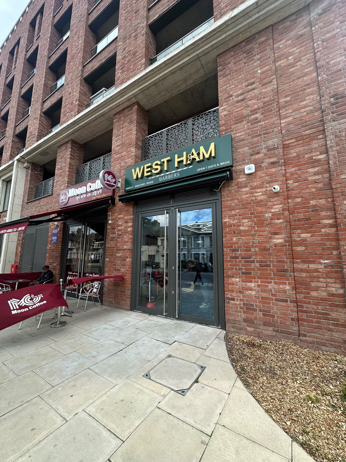 Street view of the barbershop next to Moon Coffee